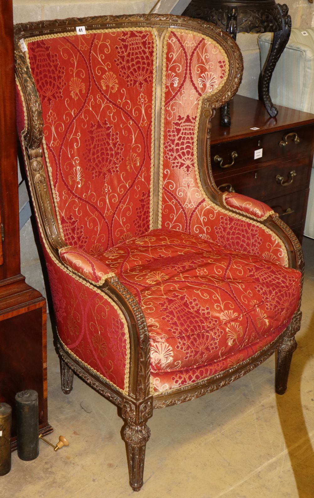 A late 19th century mahogany wing armchair with foliate and scroll carved frame, W.80cm, H.112cm